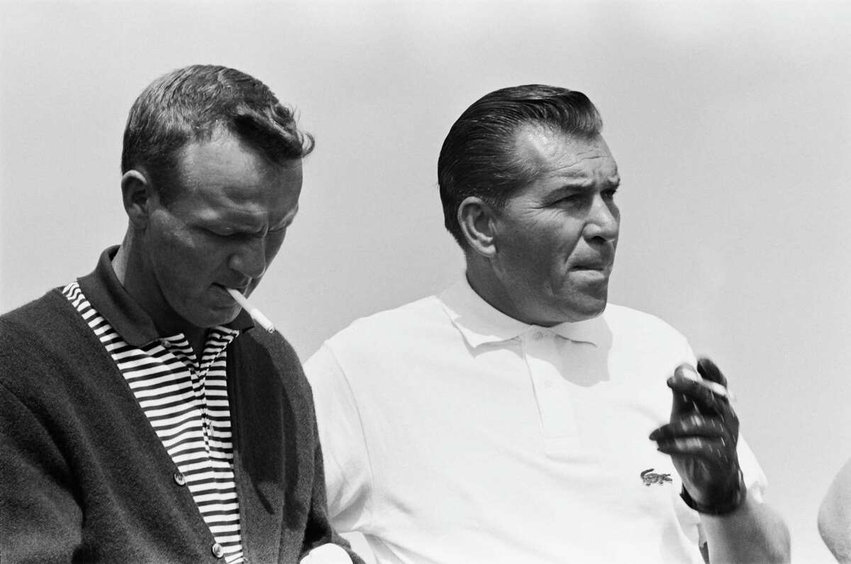 Arnold Palmer, left, and Julius Boros take a break during the 1963 World Series of Golf.