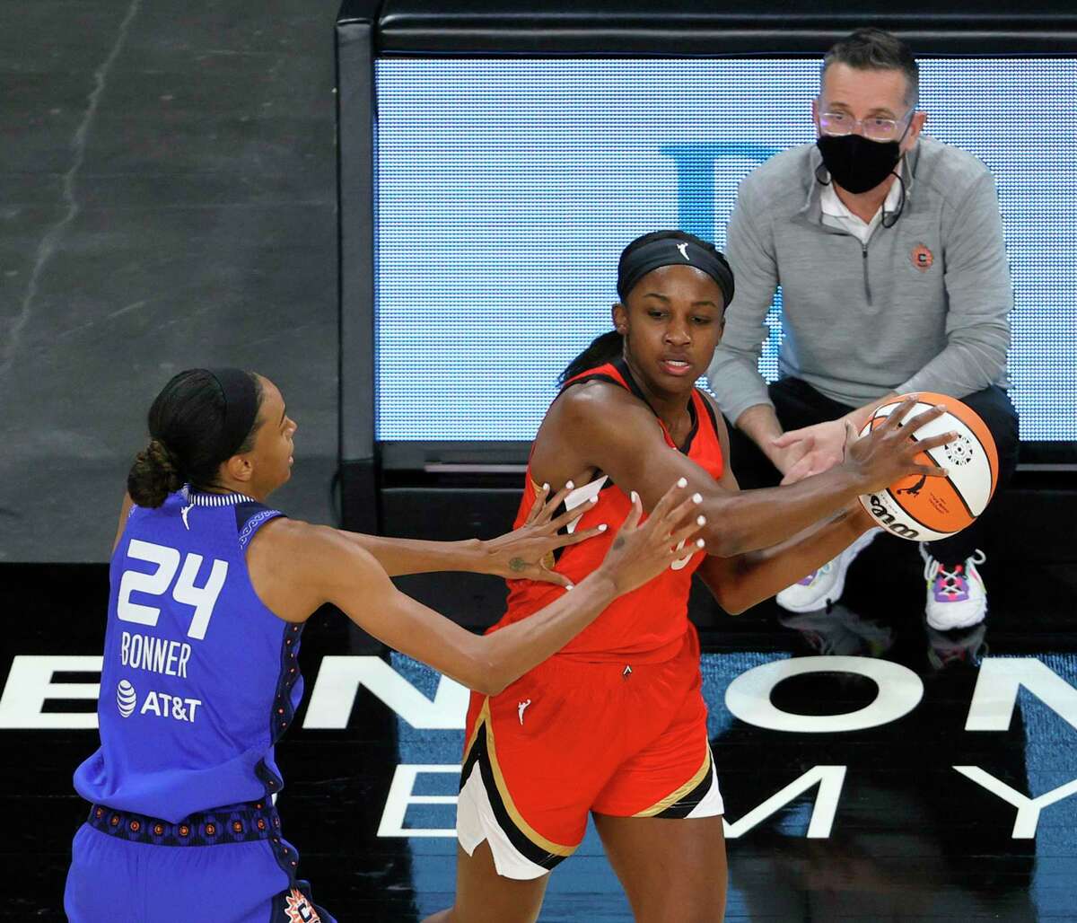 LAS VEGAS, NEVADA - MAY 23: Jackie Young #0 of the Las Vegas Aces looks to pass against DeWanna Bonner #24 of the Connecticut Sun as head coach Curt Miller of the Sun looks on during their game at Michelob ULTRA Arena on May 23, 2021 in Las Vegas, Nevada. The Sun defeated the Aces 72-65. NOTE TO USER: User expressly acknowledges and agrees that, by downloading and or using this photograph, User is consenting to the terms and conditions of the Getty Images License Agreement. (Photo by Ethan Miller/Getty Images)