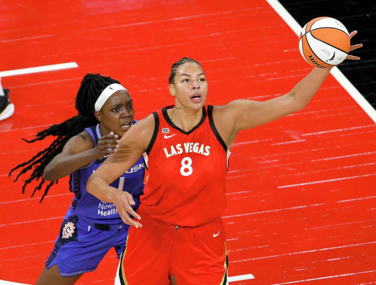 LAS VEGAS, NEVADA - MAY 23: Liz Cambage #8 of the Las Vegas Aces catches a pass under pressure from Beatrice Mompremier #1 of the Connecticut Sun during their game at Michelob ULTRA Arena on May 23, 2021 in Las Vegas, Nevada. The Sun defeated the Aces 72-65. NOTE TO USER: User expressly acknowledges and agrees that, by downloading and or using this photograph, User is consenting to the terms and conditions of the Getty Images License Agreement. (Photo by Ethan Miller/Getty Images)
