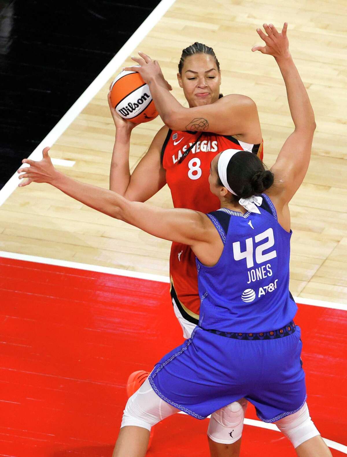 The Aces' Liz Cambage grabs a rebound over the Sun's Brionna Jones on Sunday in Las Vegas.