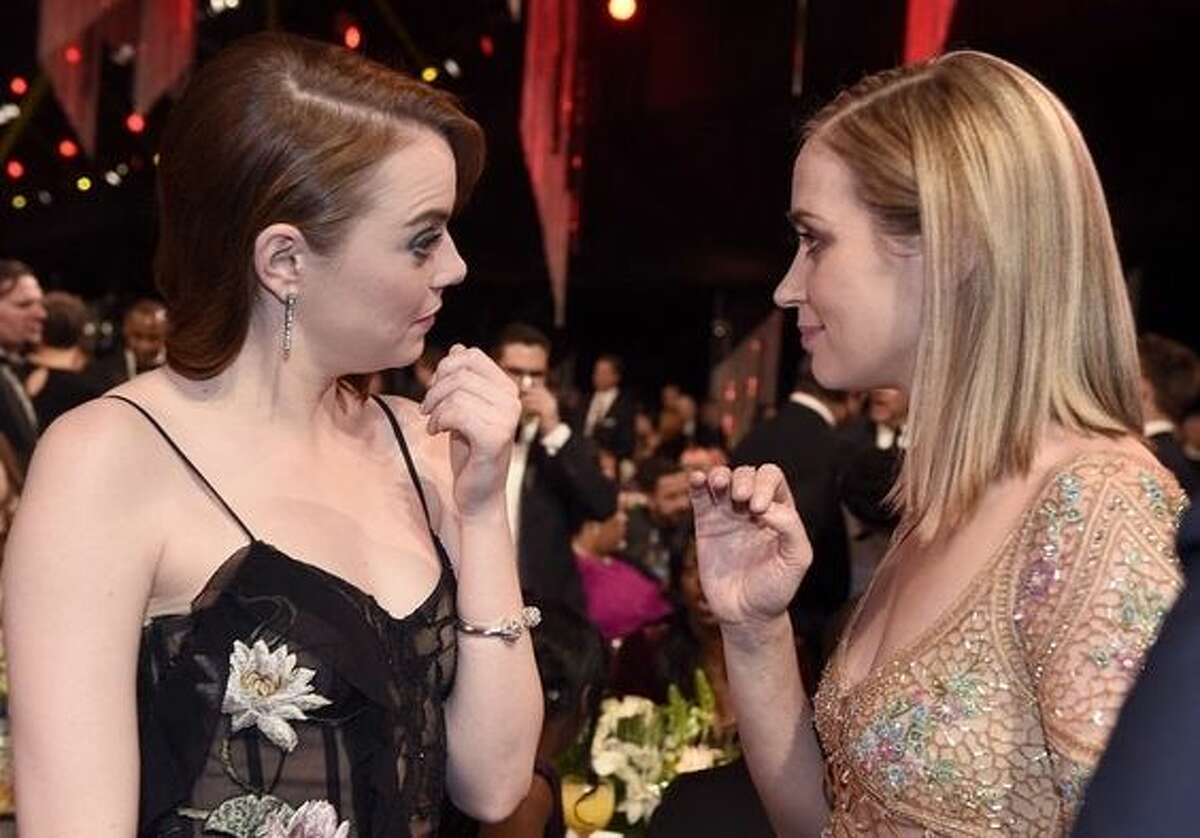 Could Emma Stone, left, and Emily Blunt be talking smack about the curiously absent Emma Thompson?