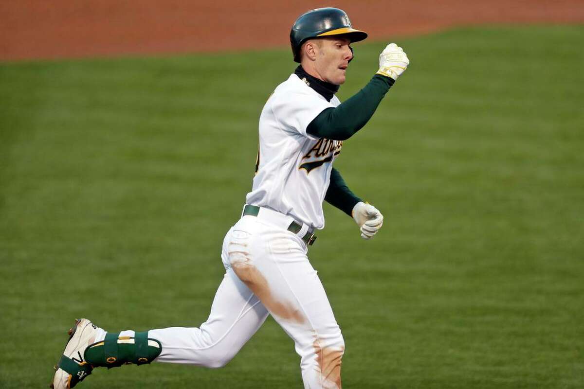 Oakland Athletics' Mark Canha rounds the bases after his solo home run against Seattle Mariners in 3rd inning of MLB game at Oakland Coliseum in Oakland, Calif., on Monday, May 24, 2021.