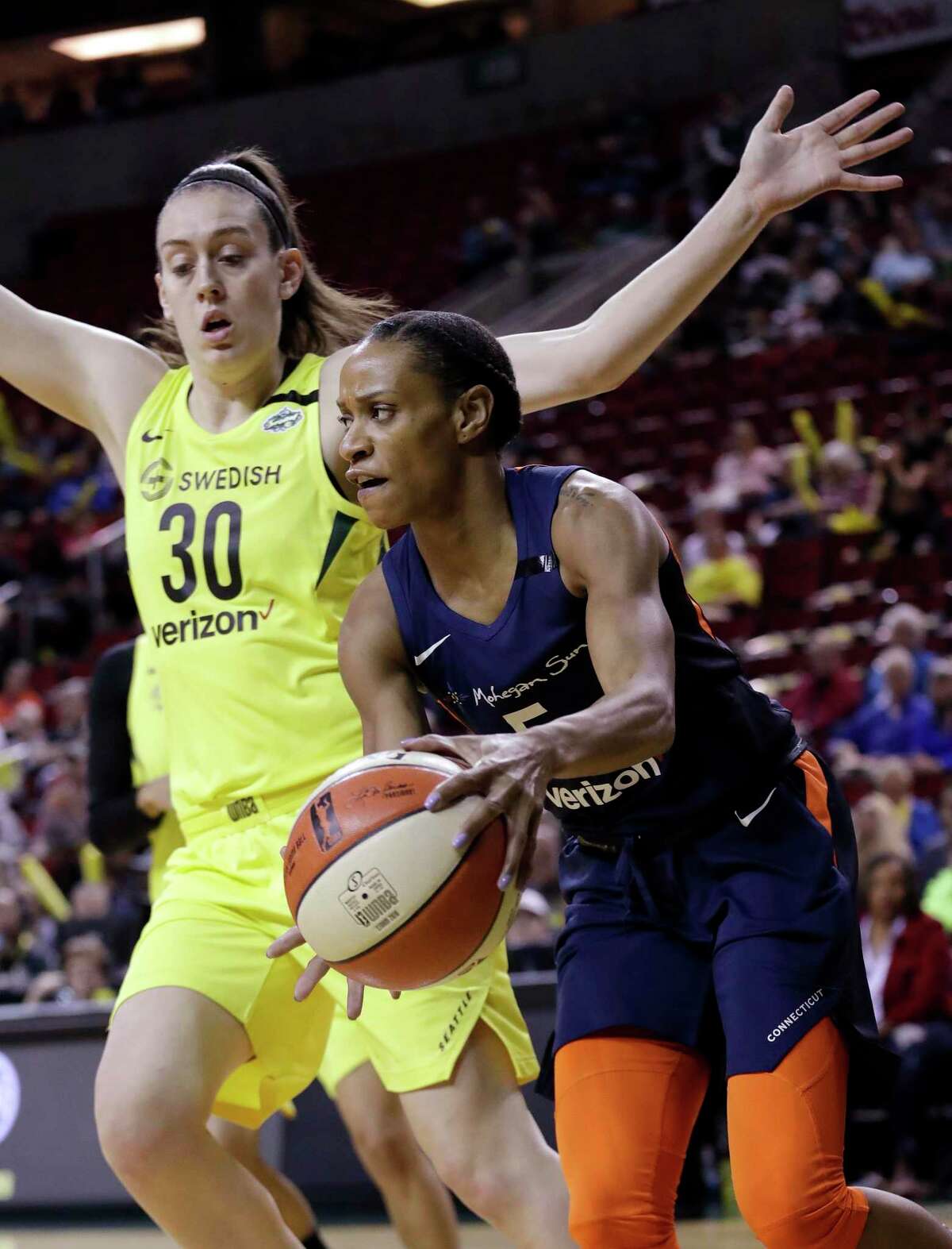 Connecticut Sun's Jasmine Thomas, right, tries to drive past Seattle Storm's Breanna Stewart during the first half of a WNBA basketball game Friday, June 15, 2018, in Seattle. (AP Photo/Elaine Thompson)
