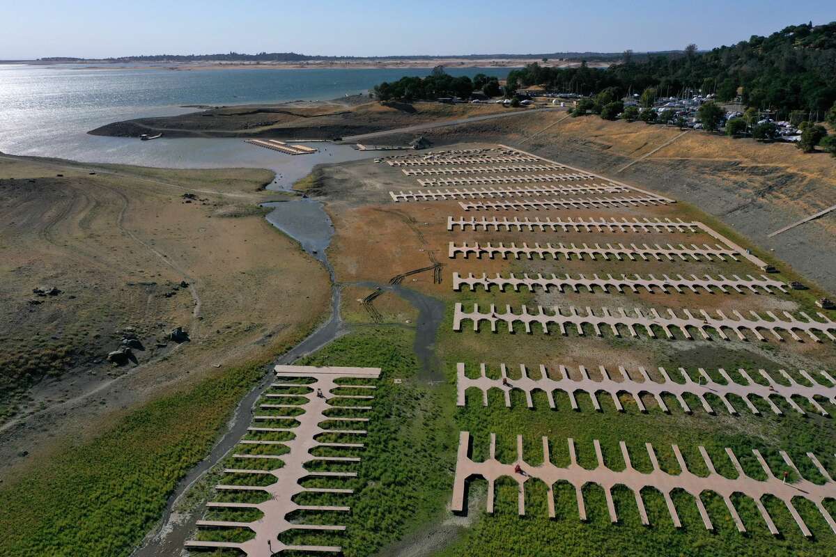 In an aerial view, boat docks at the Browns Ravine Cove sit on dry earth at Folsom Lake on May 10, 2021 in El Dorado Hills.