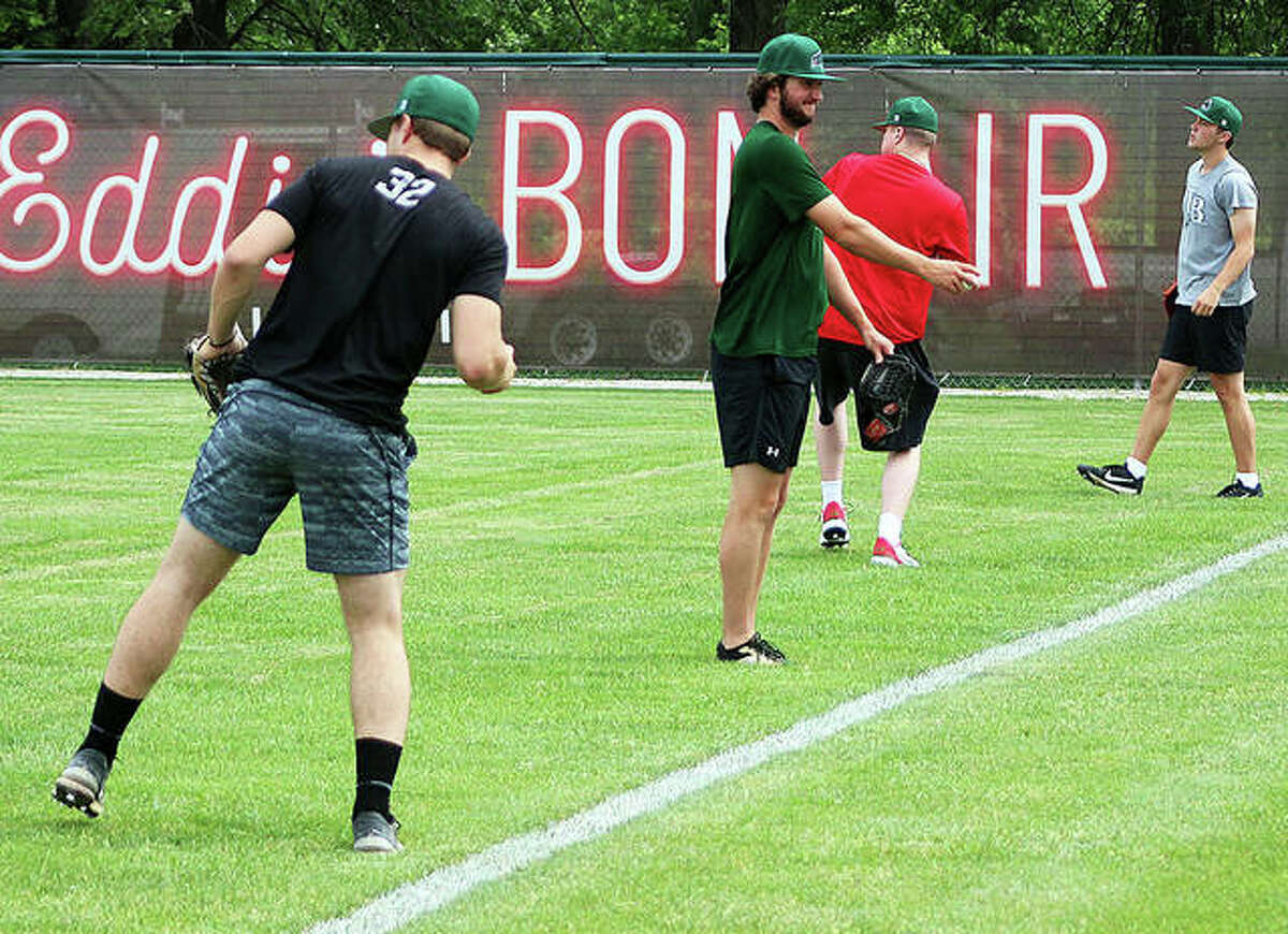 A group of Alton River Dragons players loosen up in the outfield after a team meeting Monday at Lloyd Hopkins Field in Gordon Moore Park. Monday was the first day for players to report. More are expected this week, with about 20 here in time for Thursday night’s season opener against Cape Girardeau.