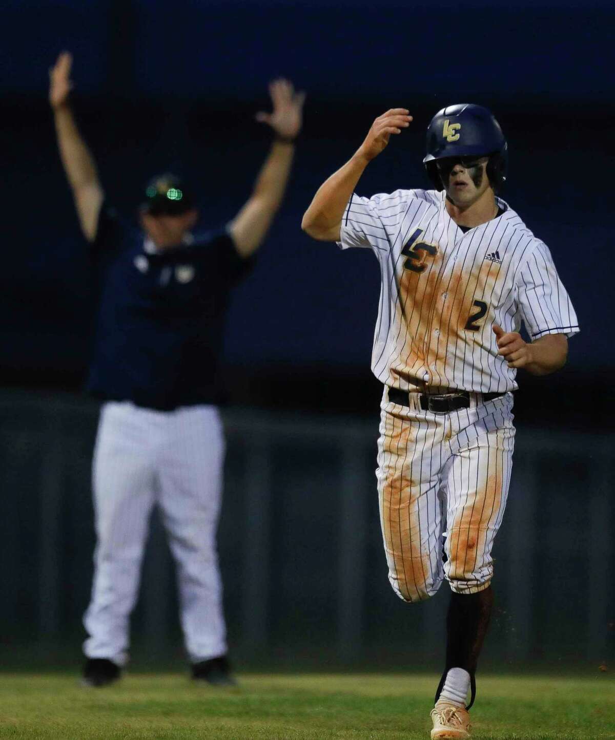 John Spikerman #2 of Lake Creek scores from second base after a thowing error during the fourth inning of a District 20-5A high school baseball game at Lake Creek High School, Tuesday, April 27, 2021, in Montgomery.