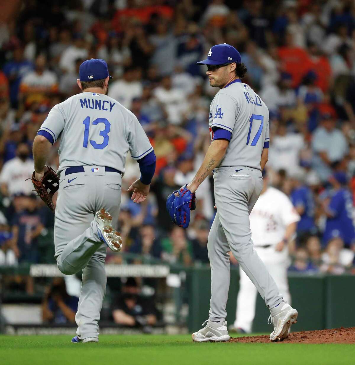 Los Angeles Dodgers relief pitcher Joe Kelly (17) chats with Max Muncy (13) after Houston Astros Jose Altuve ground out to end the eighth inning of an MLB baseball game at Minute Maid Park, Tuesday, May 25, 2021, in Houston.