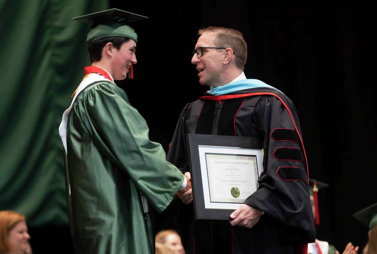 Conroe ISD Superintendent Curtis Null, right, shares a laugh with Class valedictorian Jack Andrew Northcott during The Woodlands High School's graduation ceremony at the Cynthia Woods Mitchell Pavilion, Tuesday, May 25, 2021, in The Woodlands.