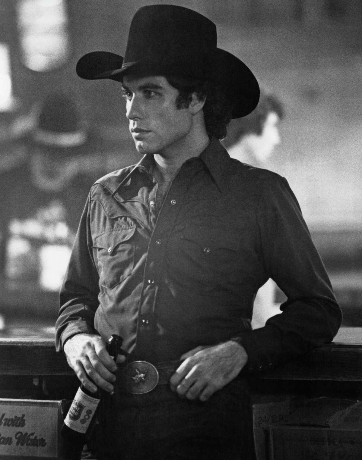 John Travolta with a bottle of Lone Star beer in the 1980 film, “Urban Cowboy.”