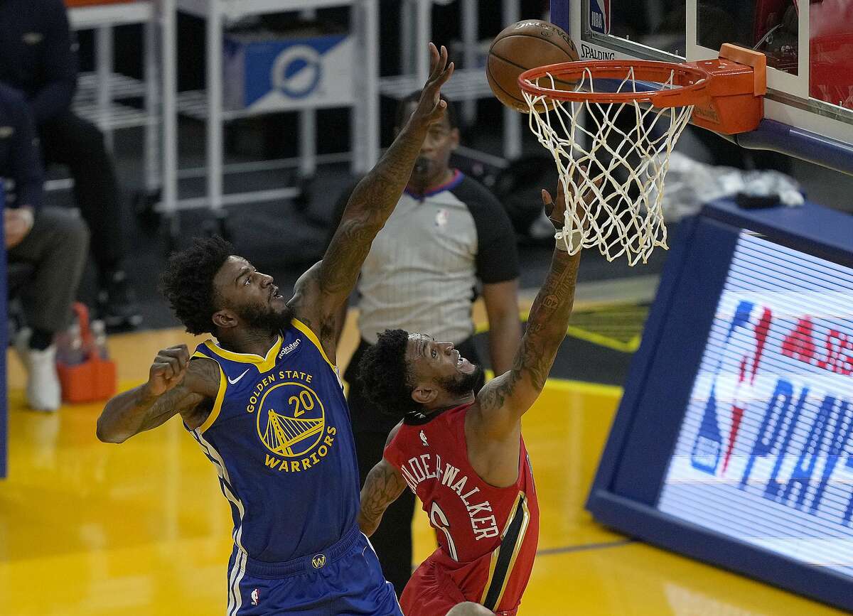 Golden State Warriors' Jordan Bell (20) blocks New Orleans Pelicans guard Nickeil Alexander-Walker (6) during the first half of an NBA basketball game on Friday, May 14, 2021, in San Francisco. (AP Photo/Tony Avelar)