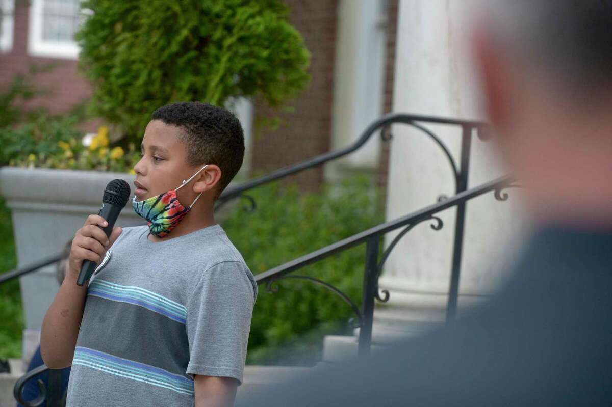 Kenneth Miller, age 10, of Newtown, speaks about an incident directed at him in school at a Newtown Allies for Change peace rally on Tuesday evening, the one year anniversary of George Floyd's slaying in Minnesota. The rally was held in front of the Edmond Town Hall, in Newtown, Conn, May 25, 2021.