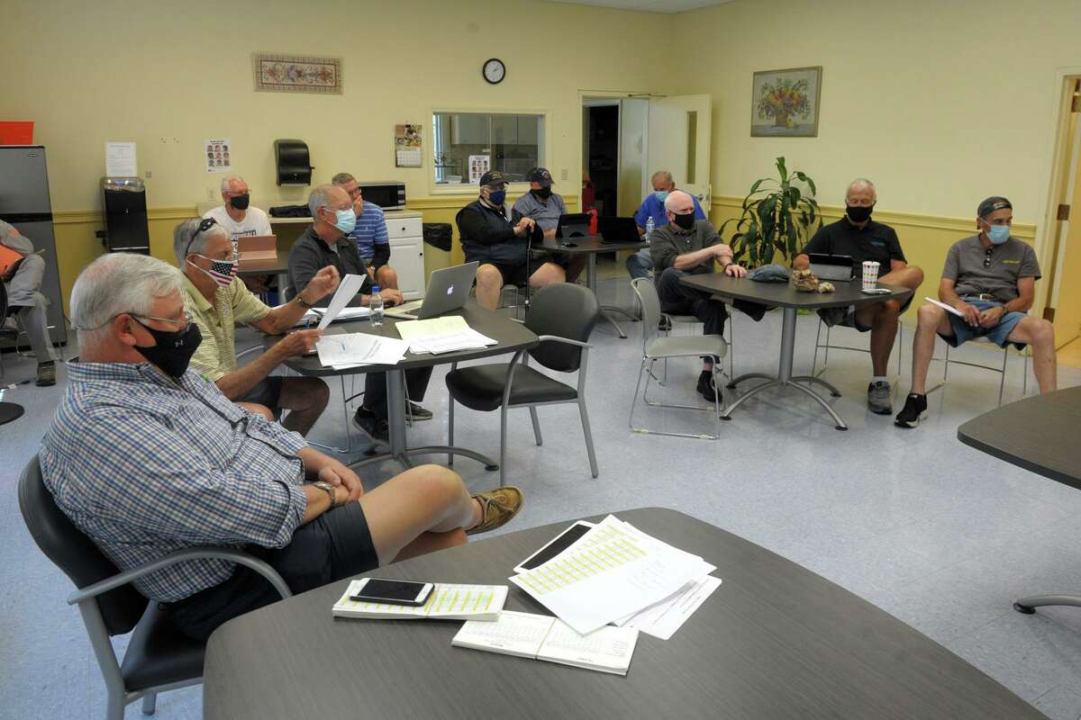 The Trumbull Senior Center men's club hold their first in person meeting in over a year, in Trumbull, Conn. May 25, 2021.