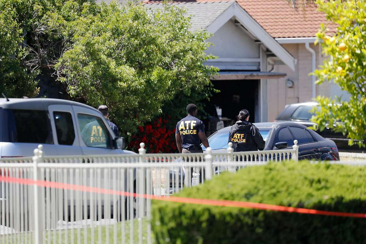 ATF investigators gather at a home, with garage door open, on Angmar Court in San Jose, owned by Samuel Cassidy, suspected of killing eight people and himself at a VTA service yard in San Jose on Wednesday.