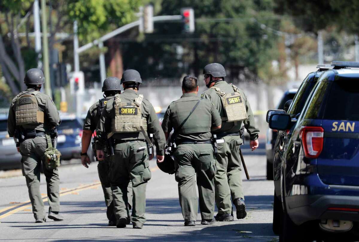 Sherrif’s deputies walk on San Pedro Street toward the First Street VTA service yard where a mass shooting took place on May 26 in San Jose, Calif.