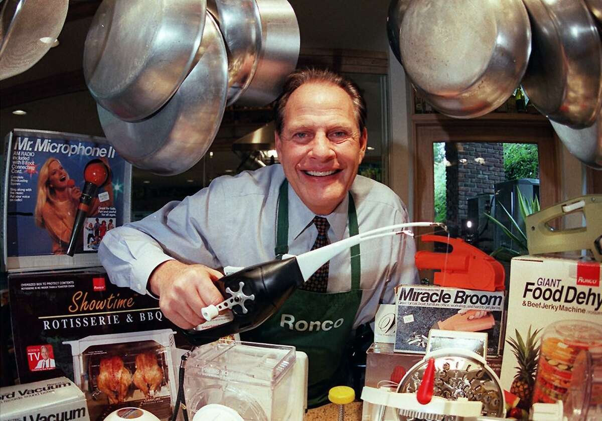 Ron Popeil, founder of Ronco Industries, stands surrounded by his products in the kitchen of his Los Angeles home in 1999.