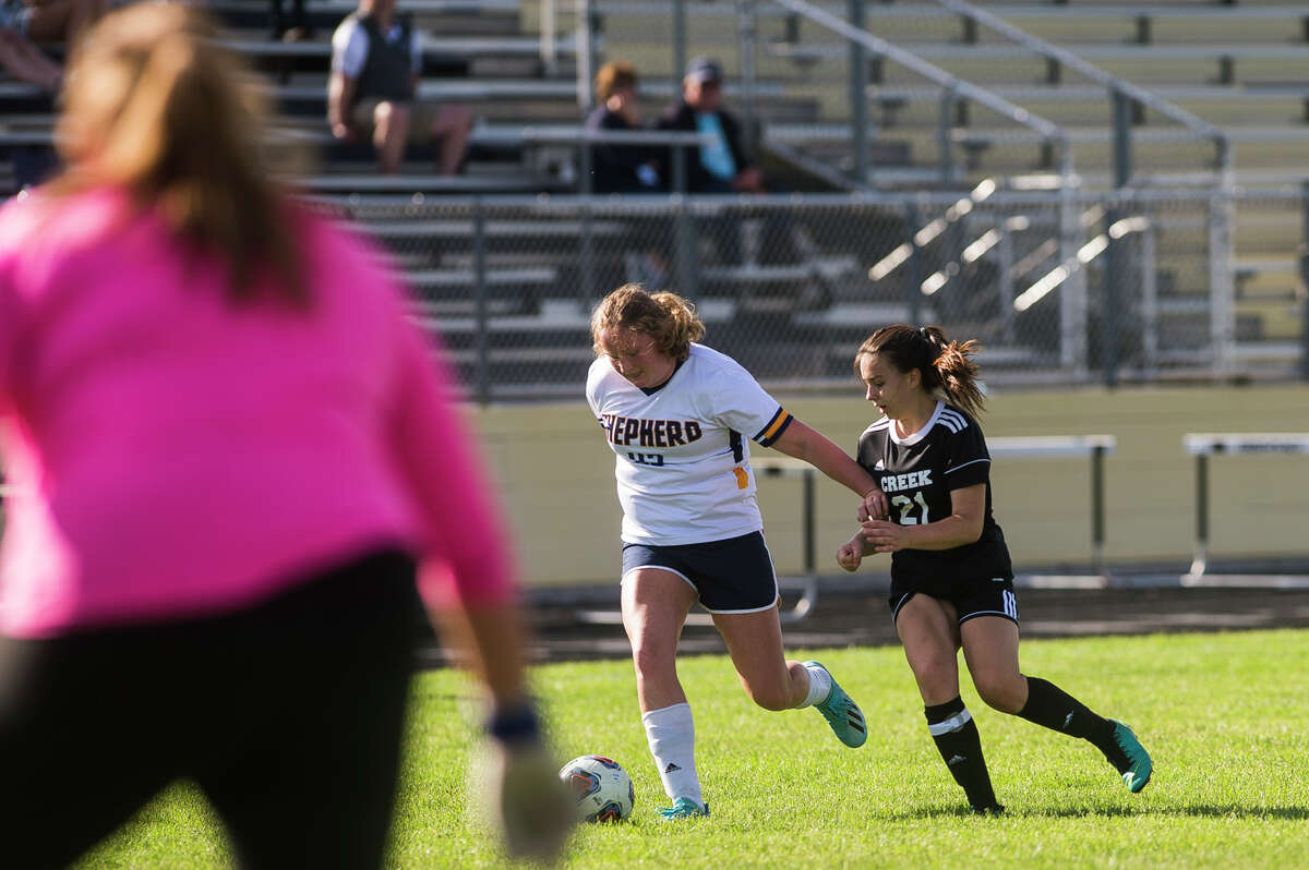 Bullock Creek's Breanna McGraw fights for possession during the Lancers' district opener against Shephed Wednesday, May 26, 2021 at Bullock Creek High School. (Katy Kildee/kkildee@mdn.net)