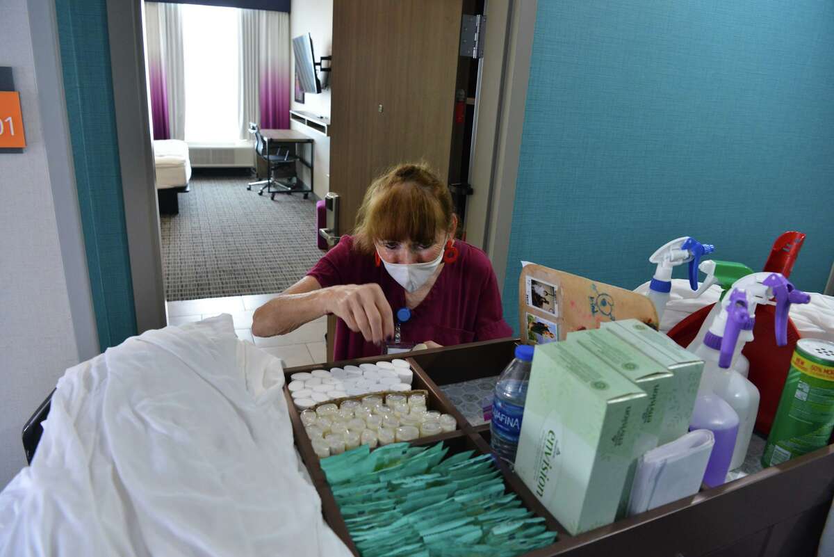 Suzanne Brouillard of the houskeeping staff at the LaQuinta Inn, 11006 N I35, tends to a guest room as the area's lodging sector begins to rebound from the pandemic.