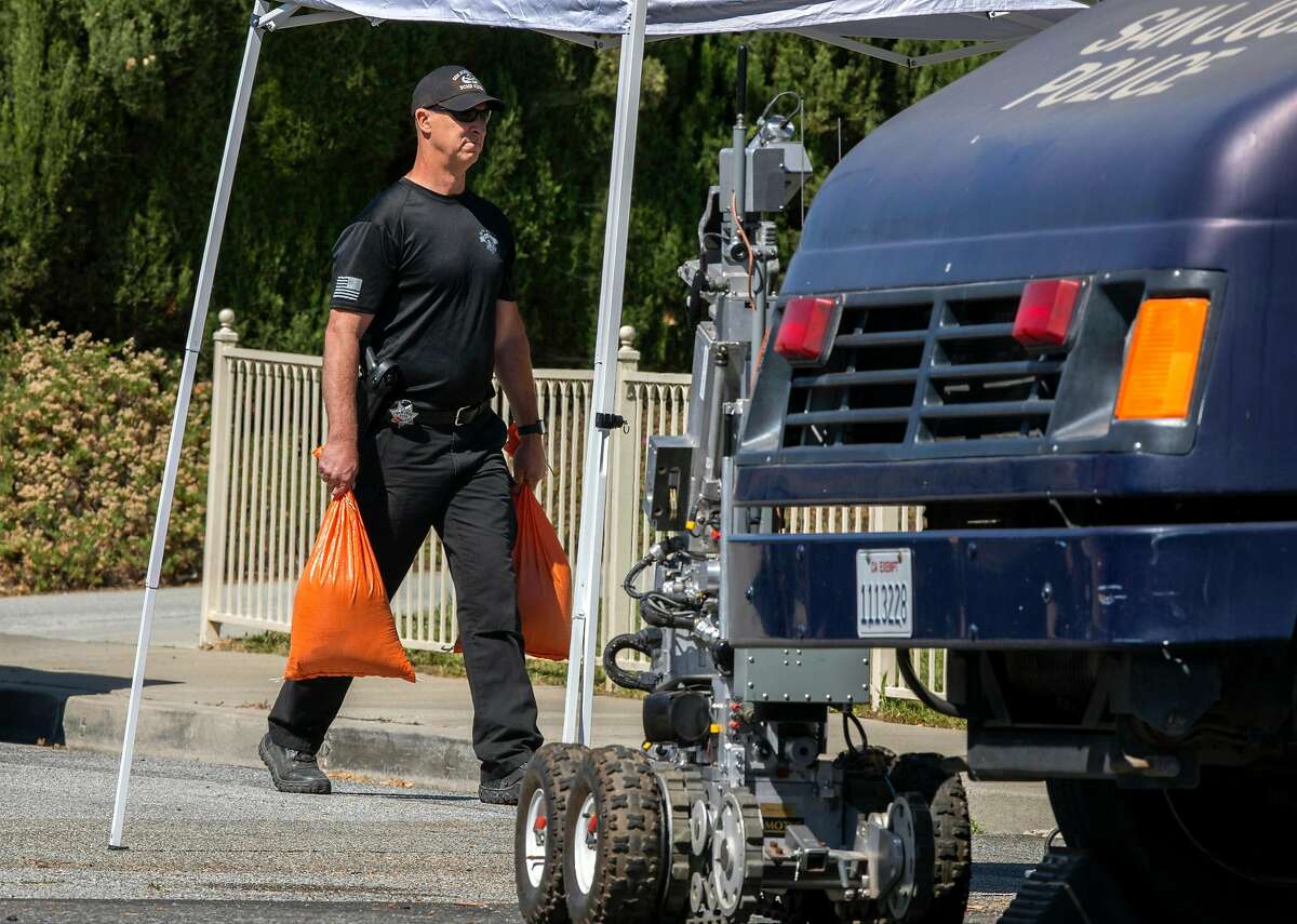The San Jose bomb squad collects evidence outside the home of Samuel James Cassidy. Evidence collection at various scenes will be time-consuming.