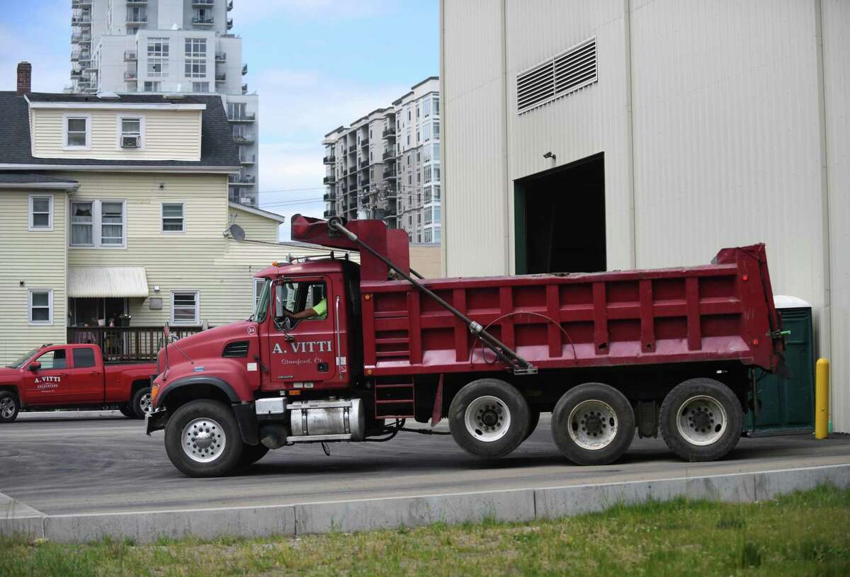 Trucks are parked outside the A. Vitti Construction facility in southern Stamford, Connecticut on Monday, May 24, 2021. Tensions in the southern part of the city began to escalate after new complaints of illegal activity crushing plant at 35 Harbor Street.  A. Vitti has built a structure to enclose any potential rock crushing operation, but the structure is not complete and neighbors continue to raise concerns about noise and air quality.