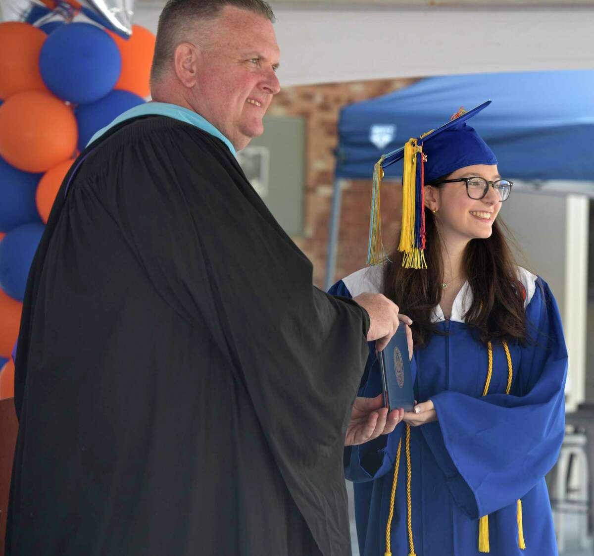 Principal Daniel Donovan posses for a photograph with graduate Rebecca Leigh Andersen during the 2020 Danbury High School graduation, Wednesday, June 10, 2020, at Danbury High School, Danbury, Conn. Graduation is taking place over three days, June 10, 11, and 12.