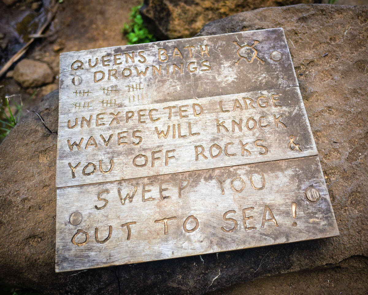 A sign at Queen's Bath warns visitors of the danger of being swept out to sea.