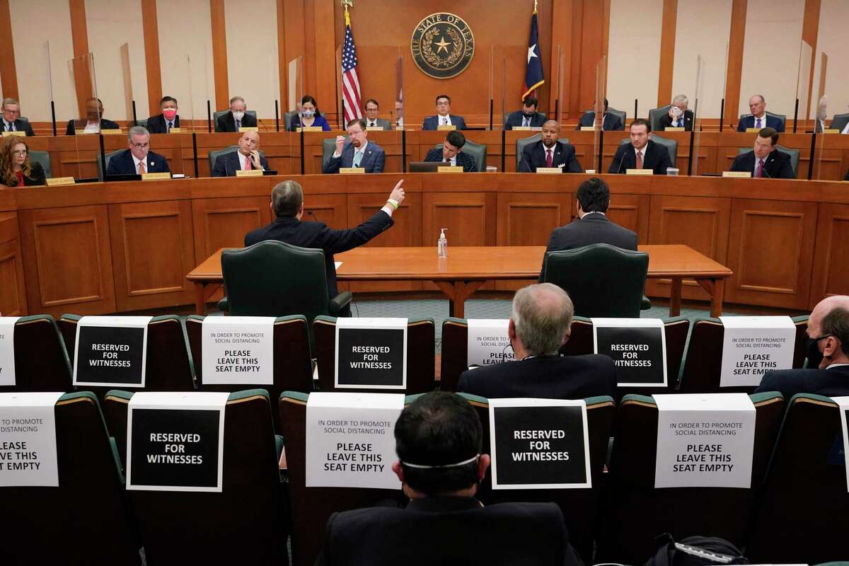In this Feb. 25, 2021 file photo, Curtis Morgan, the CEO of Vistra Corp., at table left, testifies as the Committees on State Affairs and Energy Resources holds a joint public hearing to consider the factors that led to statewide electrical blackouts, in Austin, Texas.