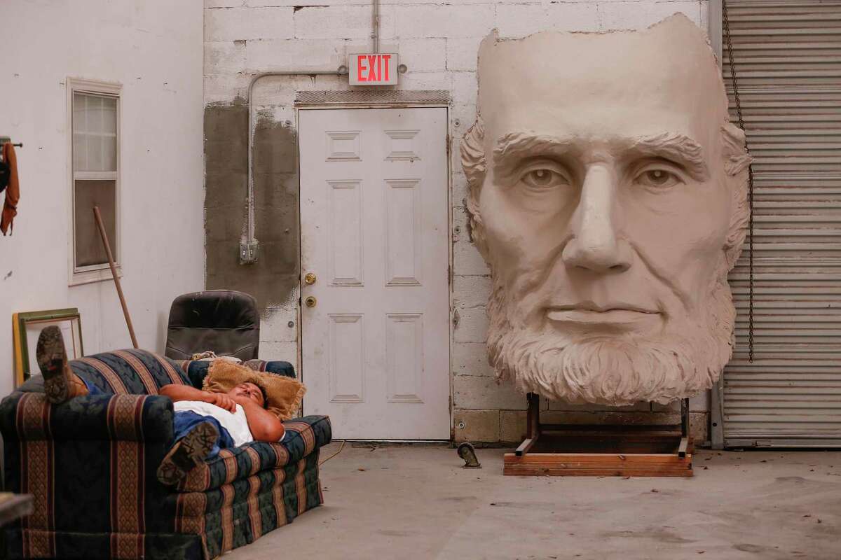 The face of David Adickes' President Abraham Lincoln is next to an exit door at his warehouse Tuesday, May 18, 2021, in Houston.
