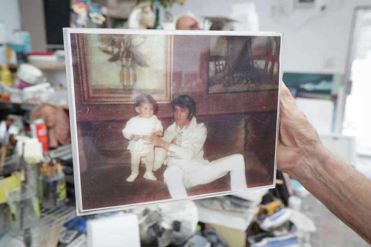 David Adickes' holds a photo of Elvis Presley that shows artwork he bought for his Graceland home Tuesday, May 18, 2021, in Houston.