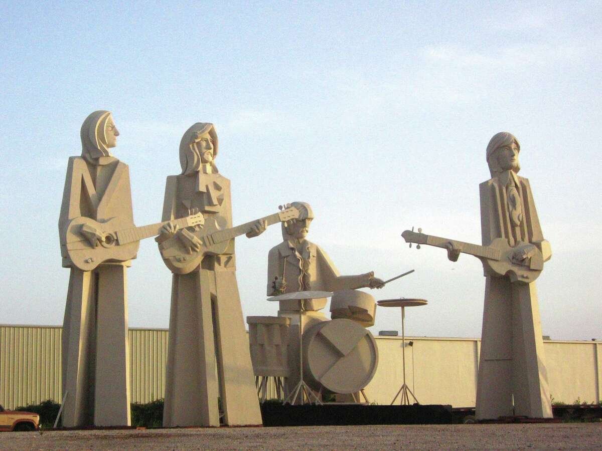 David Adickes' towering Beatles stand over 8th Wonder Brewing Co.