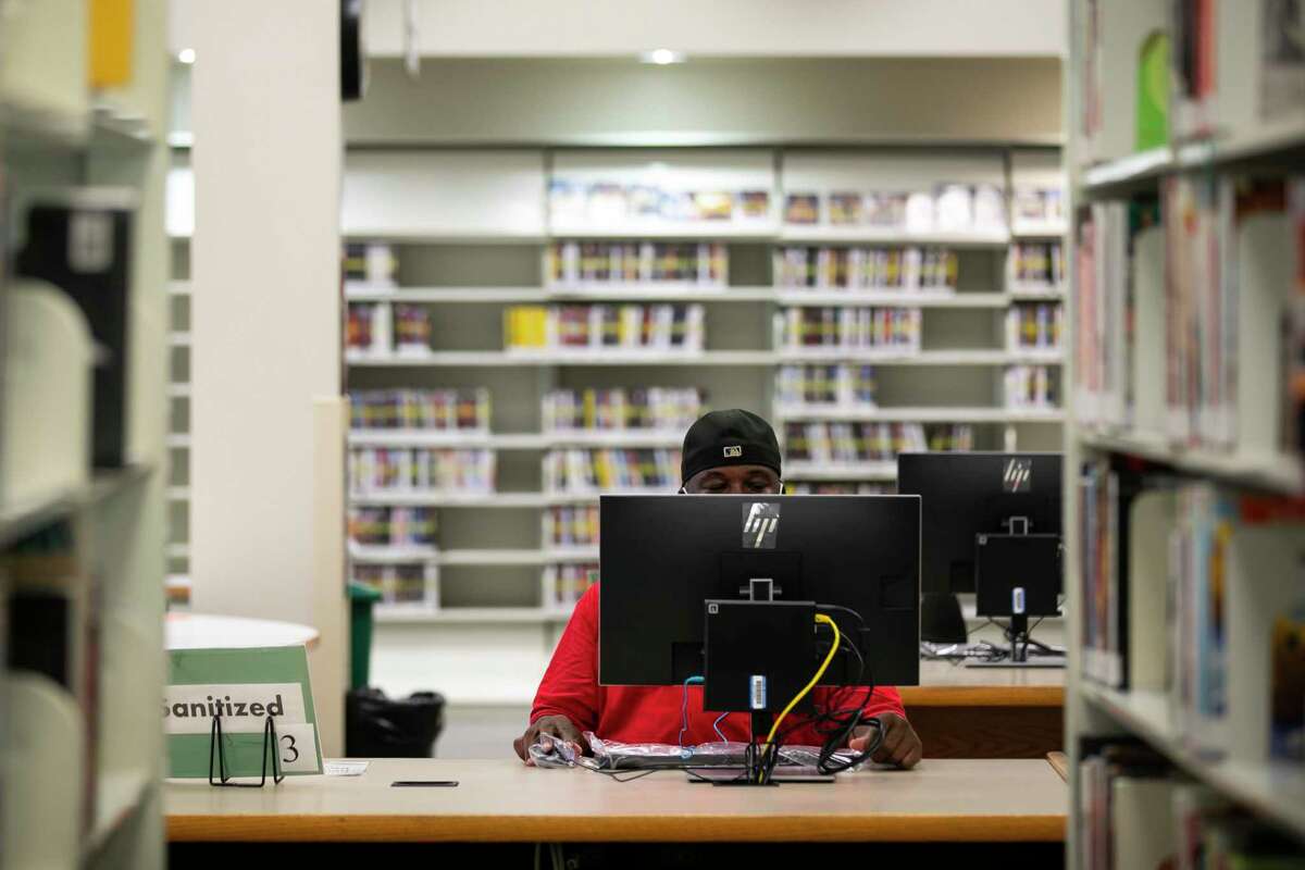 Wayne Miles uses a computer at the Smith Neighborhood Library on Monday, May 24, 2021. Miles has been using the library since he was sixteen years old. Eleven neighborhood libraries are now open for browsing, internet and other services in Houston.