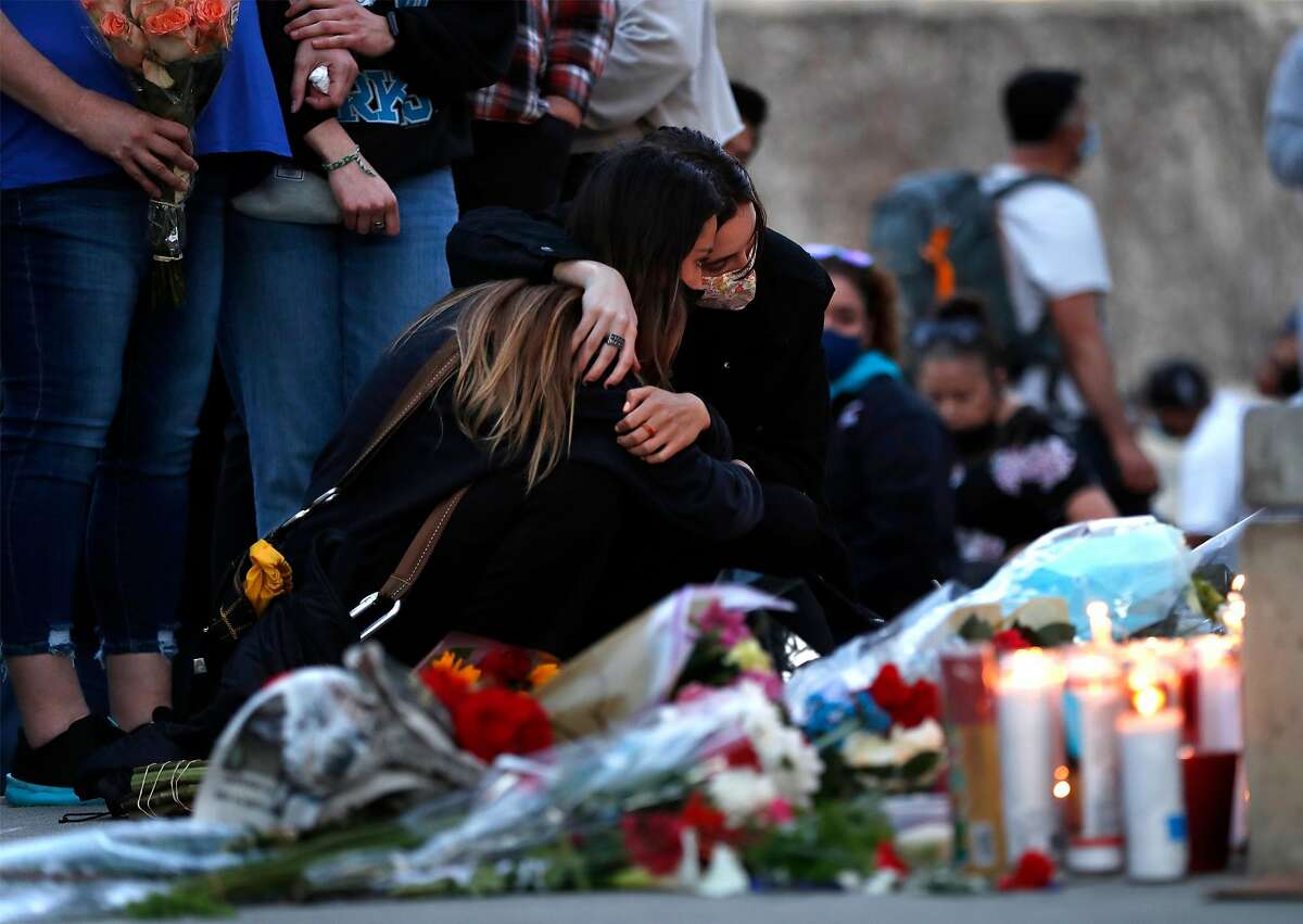 Eva Hernandez, (left) the sister of victim Jose Hernandez, is comforted by Emma Lechenne as they visit a memorial on Thursday, May 27, 2021, at San Jose City Hallin wake of Wednesday's mass shooting at Valley Transportation Authority's maintenance yard in San Jose, Calif..