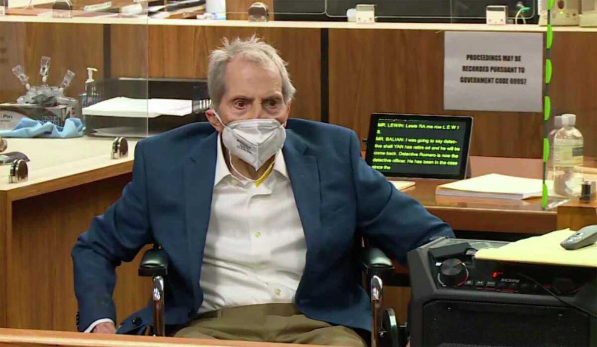 Robert Durst watches his defense attorney, Dick DeGuerin present a new round of opening statements in the murder case against Durst after a 14-month recess due to the coronavirus pandemic in Los Angeles County Superior Court in Inglewood, Calif., on Wednesday, May 19, 2021.