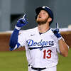 Max Muncy #13 of the Los Angeles Dodgers celebrates his solo homerun to take a 4-3 lead over the San Francisco Giants, during the sixth inning at Dodger Stadium on May 27, 2021.