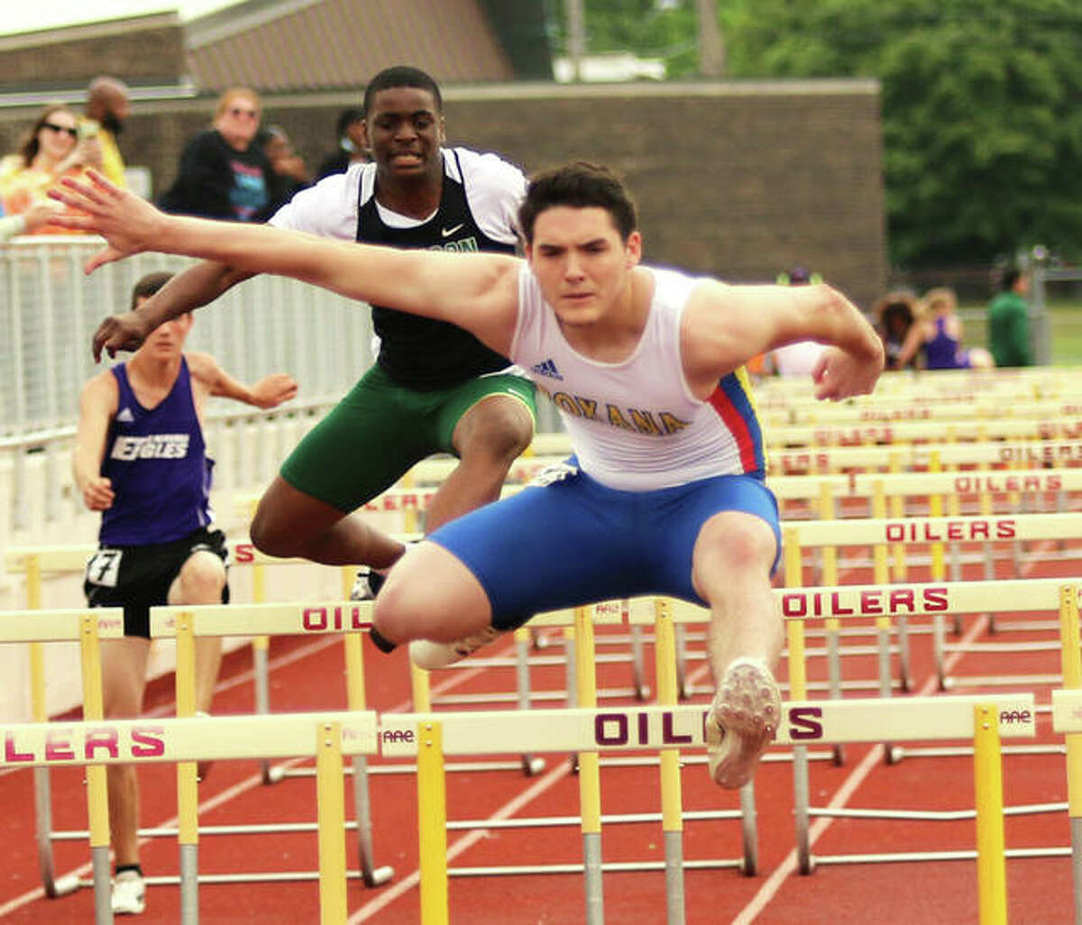 Roxana’s Aidan Flener (front) clears a hurdle at the Madison County Meet on May 17 in Wood River. On Thursday at the SCC Meet in Pana, Flener was second in the 100 hurdles and third in the 300 hurdles.
