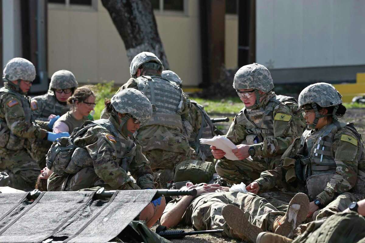 U.S. Army medics in training in 2017 at Fort Sam Houston include (center left to right) Pvt. Margie Jiminez, 18, of Houston, Pfc. Ronald Cross, 19, of Washington, D.C. and Pfc. Irene Cheng, 19, of Seattle. With the pandemic easing, trainees will be allowed off the post this weekend to visit San Antonio for the first time in 14 months.