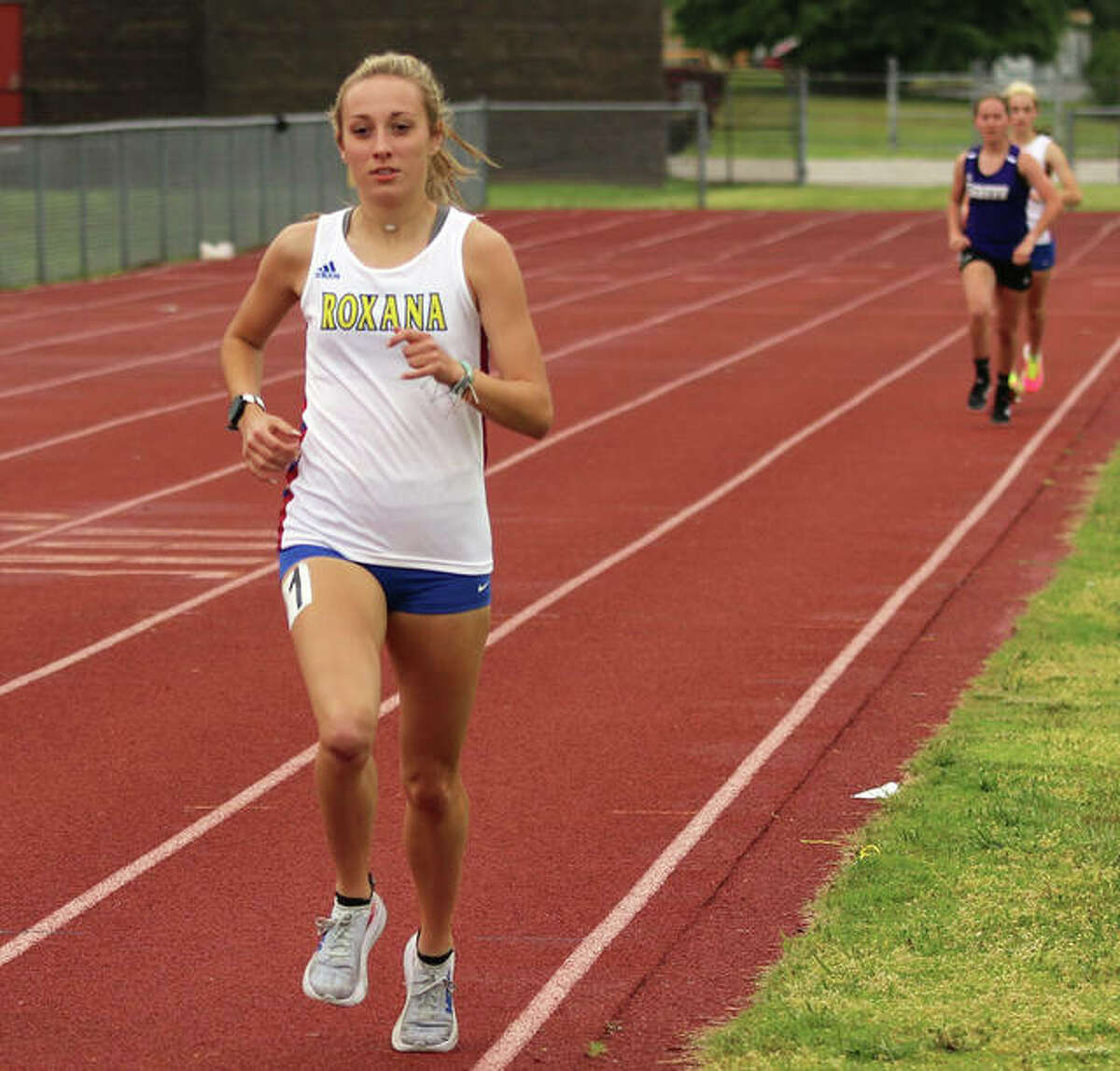 Roxana’s Janelynn Wirth (left), shown winning the 1,600 meters at the Madison County Meet on May 17 in Wood River, won the 1,600 and was second in the 3,200 on Thursday at the SCC Meet in Pana.