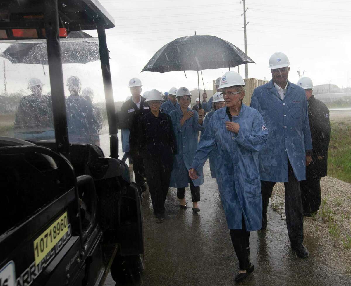 U.S. Secretary of Energy Jennifer M. Granholm, center, gets into a utility vehicle to start a tour in pouring rain at a Air Liquide hydrogen facility Friday, May 28, 2021, in La Porte.