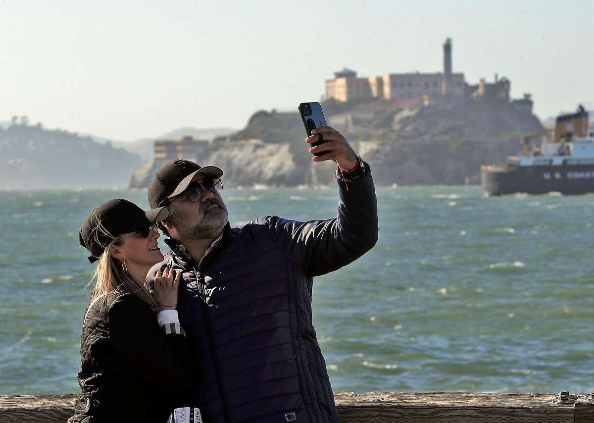 Newlyweds Jose Herrera and Aurora Aramburon, from Veracruz, Mexico, take a selfie at Pier 39 as they celebrate their honeymoon in San Francisco on May 24.