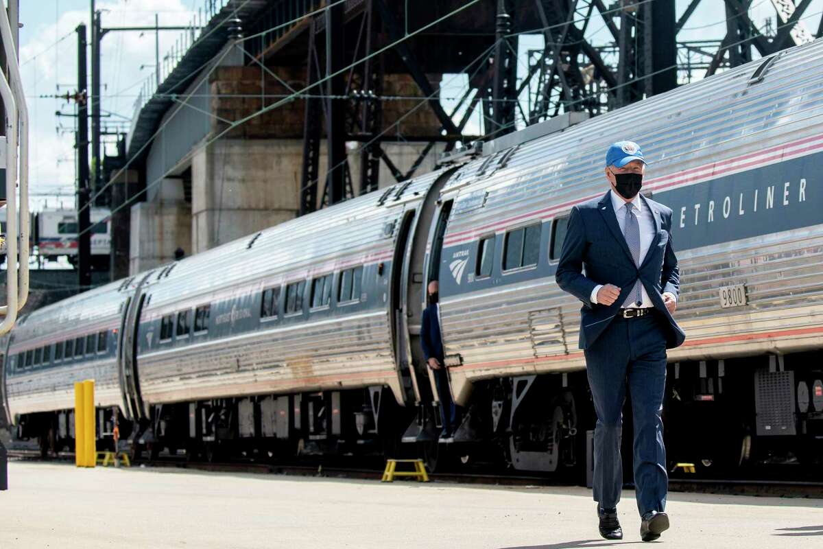 President Joe Biden runs to speak at an event marking Amtrak's 50th anniversary, in Philadelphia, on April 30, 2021. For the majority of his political career, Biden was a rail commuter, making the 90-minute Amtrak Metroliner trip between Washington and his home in Wilmington, Delaware, when the Senate was in session.