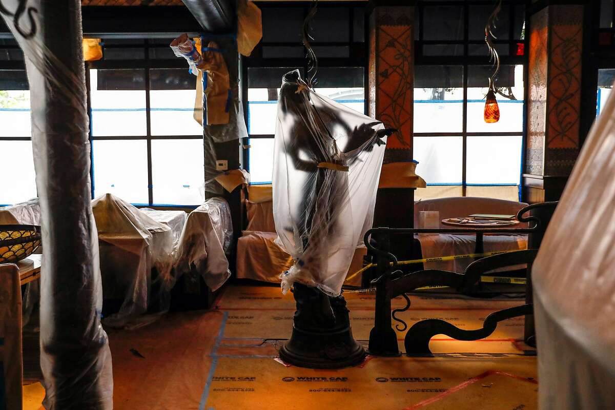 Top: A sculpture is covered in plastic during renovations at Boulevard restaurant in San Francisco.