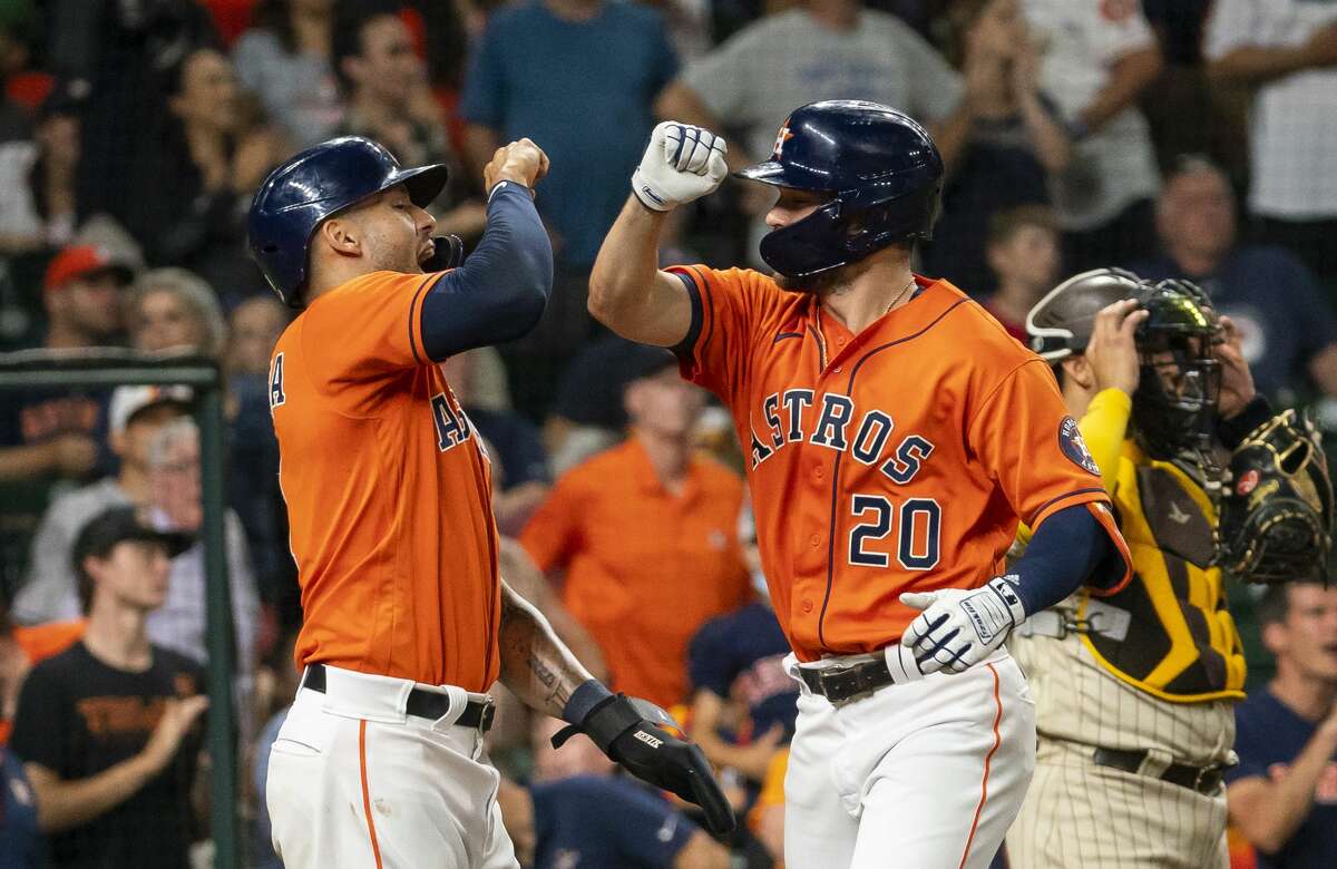 Houston Astros right fielder Chas McCormick (20) celebrates with Houston Astros shortstop Carlos Correa (1) after hitting a two-run home run during the fourth inning of an MLB game between the Houston Astros and San Diego Padres on Friday, May 28, 2021, at Minute Maid Park in Houston.