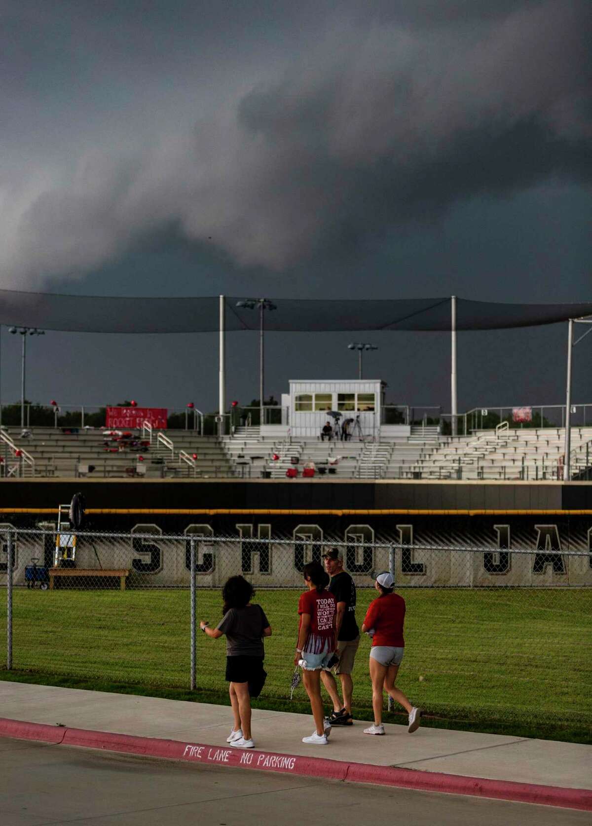 Fans leave the stadium Friday, May 28, 2021 at Johnson High School in Buda as storm clouds and lighting cause a game delay during Judson's Class 6A state quarterfinal softball game against Austin Bowie.