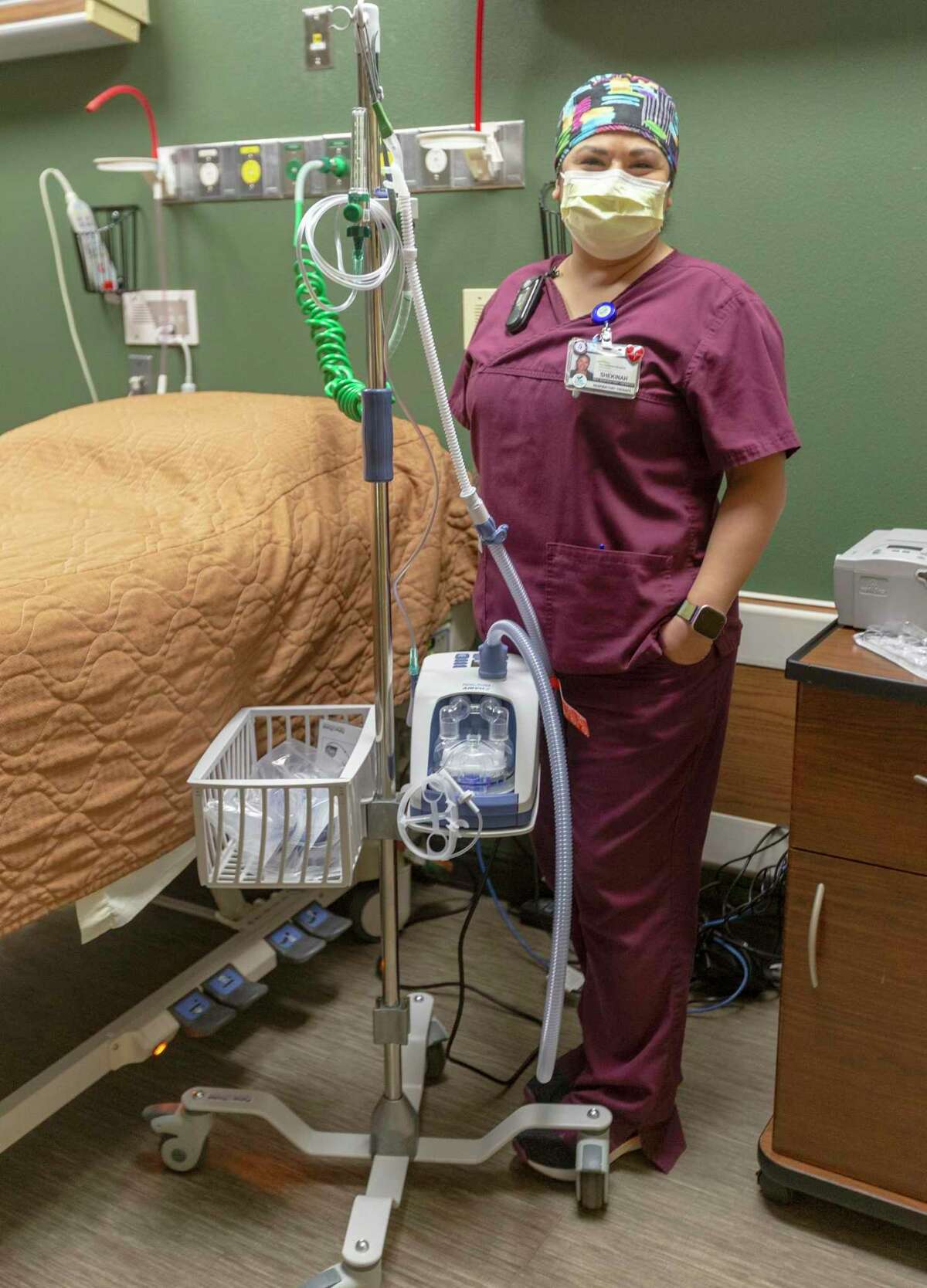 Respiratory therapist Shekinah Barrientez poses May 18 with an Airvo 2 high flow system at Christus Santa Rosa Hospital - New Braunfels. When Barrientez’s mother was at the New Braunfels hospital with COVID-19 Barrientez used an Airvo to provide her mother Nasal High Flow Therapy treatment which kept her mother off a ventilator.