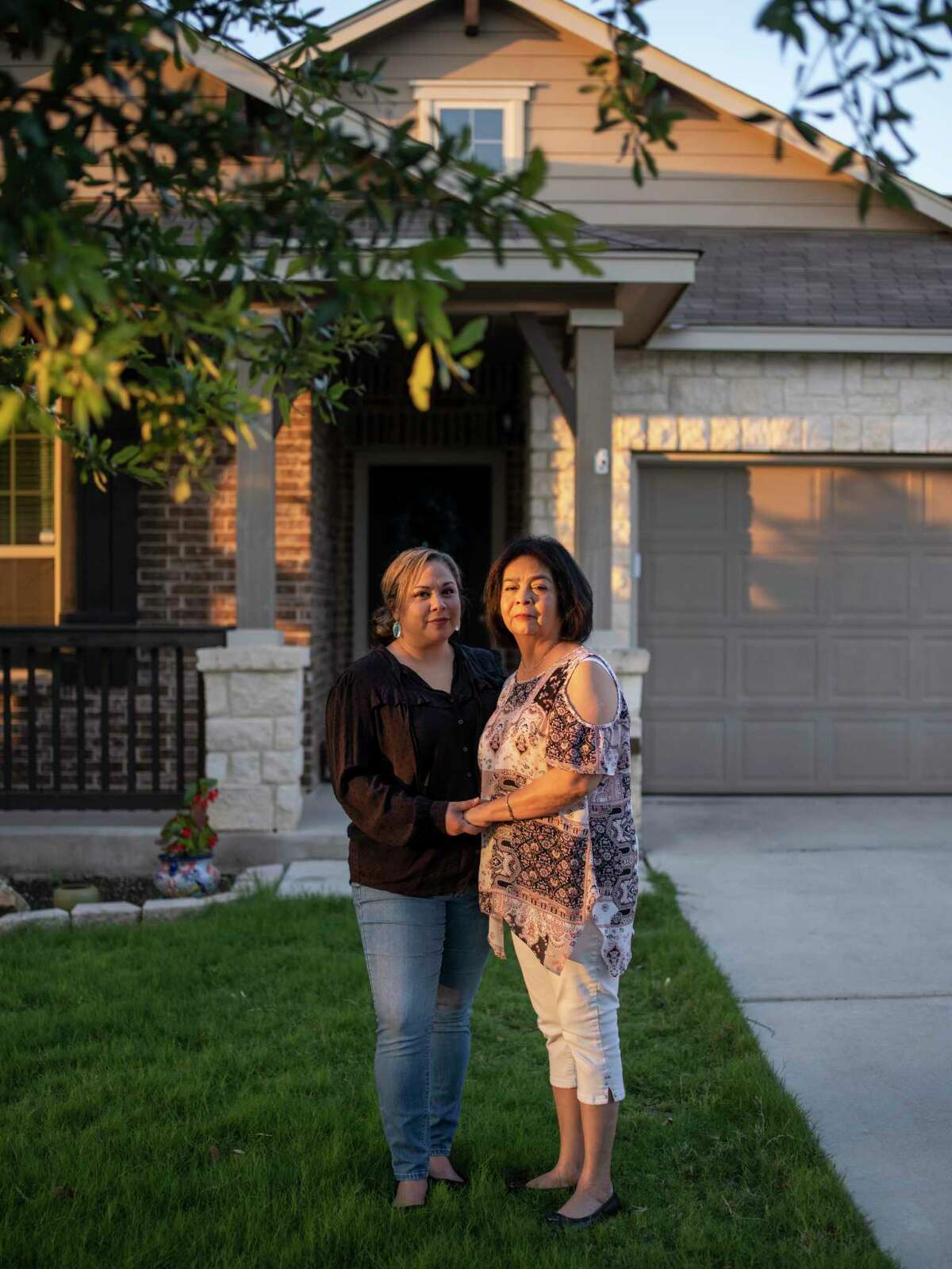 Dora Farias, right, stands for a portrait with her daughter Shekinah Barrientez, left, at Barrientez’s home in New Braunfels on Thursday, May 20. After contracting COVID-19 during summer 2020, Farias was treated with nasal high-flow therapy that she and her daughter credit with her eventual recovery from the illness.
