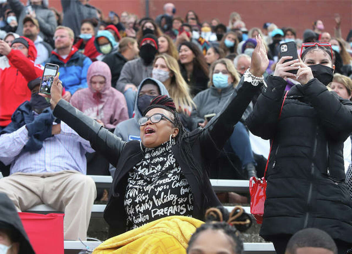 From the bleachers at Public School Stadium, Candice L. Wallace shouts out, “That’s my baby,” as her daughter, Germayia Wallace, marches in the processional to the field for the first half of the 152nd Commencement of Alton High School. The other half of the class will graduate Saturday at 11 a.m. Students arrived and were assigned classrooms of no more than 10 students to await the lineup for the procession into the stadium. The 152nd graduating class underwent many challenges trying to finish school in the middle of a worldwide pandemic.