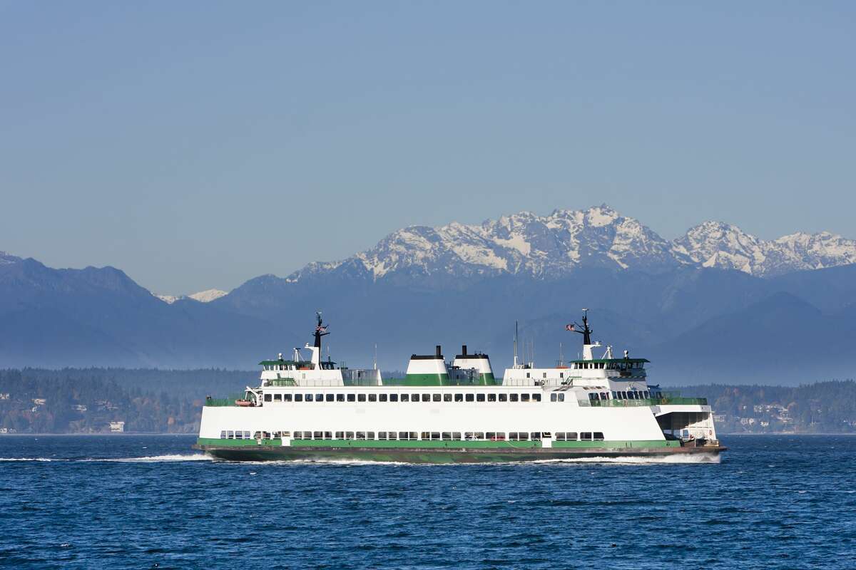 Washington State car and passenger ferry crossing Puget Sound. Olympic mountains in the background.