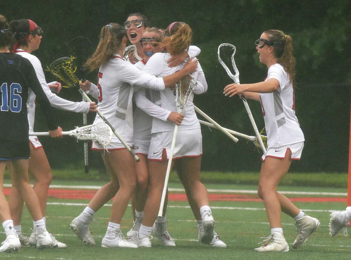 The New Canaan Rams celebrate a goal against Darien during the FCIAC girls lacrosse final at Dunning Field in New Canaan on Saturday.