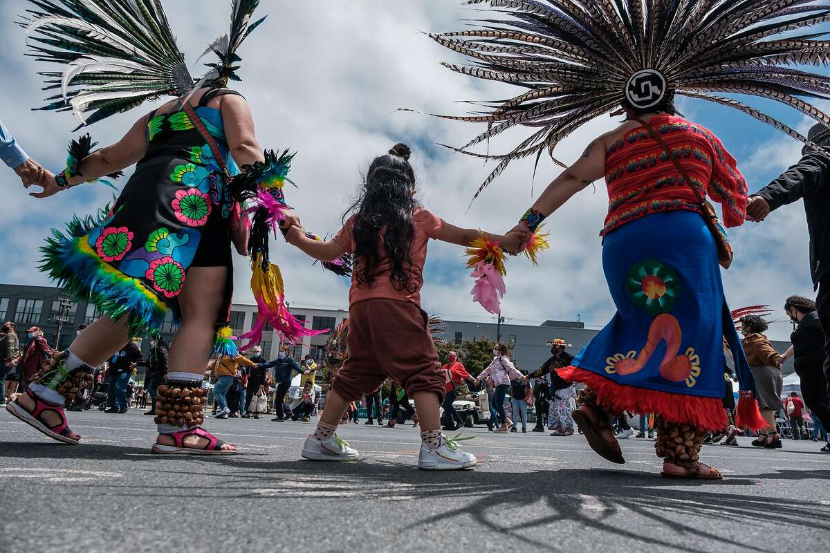 Traditional dancers and visitors perform a friendship dance to kick off the beginning of Carnaval celebrations in San Francisco on Saturday.