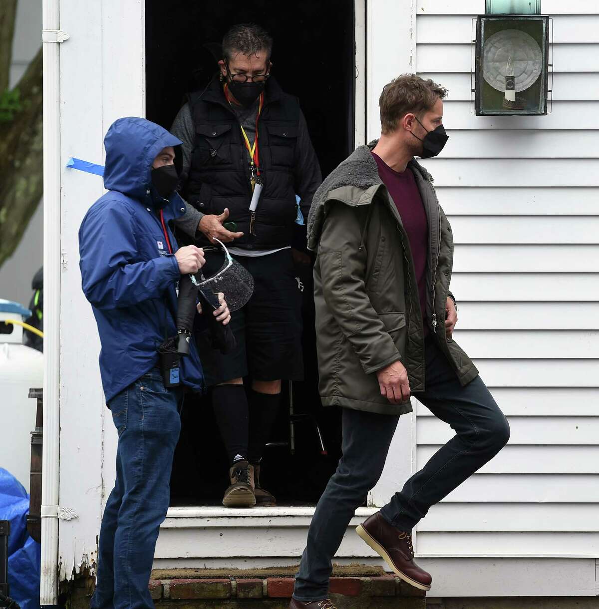 Actor Justin Hartley (right) walks between locations on the Griswold Inn property during the filming of scenes for the movie, The Noel Diary, in Essex on May 29, 2021.