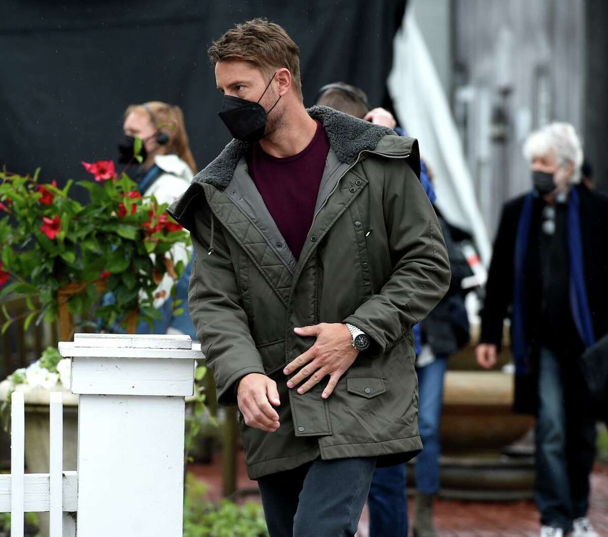 Actor Justin Hartley (center) walks to the Griswold Inn Store for the filming of a scene for the Netflix movie adaptation of the novel, “The Noel Diary,” in Essex on May 29, 2021.